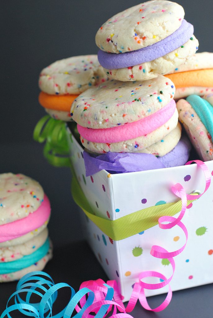 These easy funfetti cookies are made from a cake mix and super simple to make but they taste amazing. Bright and colorful, these whoopie pies are sandwiched with buttercream frosting and are a fun dessert!
