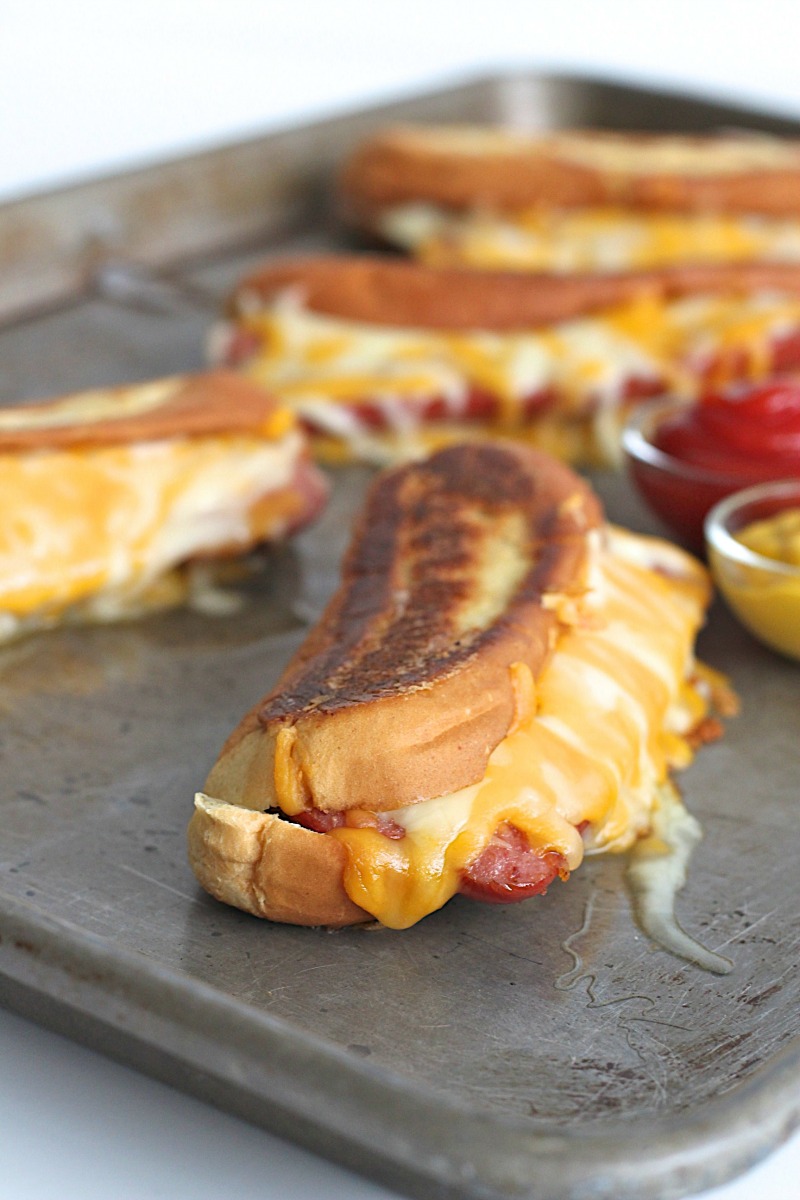 A brilliant combination of two classics: grilled cheese and hot dogs! A buttery crisp hot dog bun filled with lots of melted cheese and a juicy grilled hot dog. Why choose when you can have both?