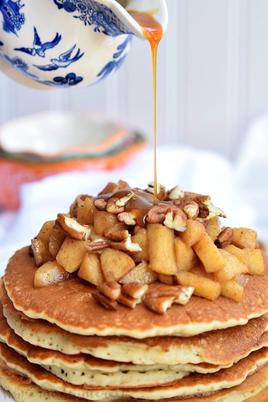 These Caramel Apple Pecan Pancakes are a fall breakfast recipe made with light and fluffy pancakes topped with caramel sauce, baked apples, and pecans.