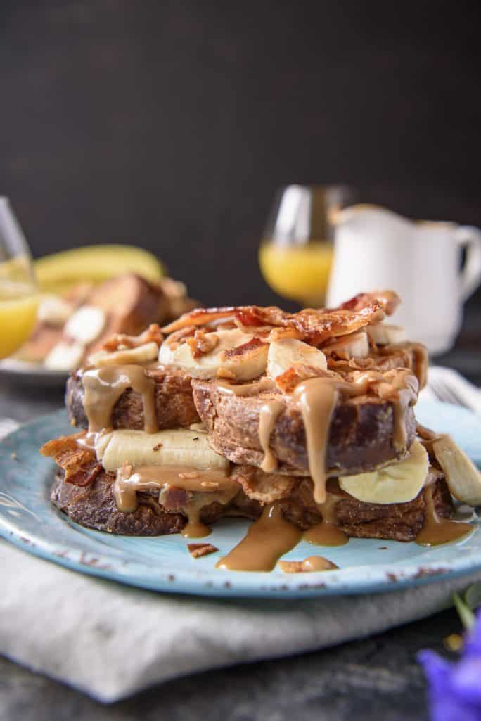 Elevate your breakfast with a batch of this incredible Elvis-Style Brioche French Toast! Fresh bananas, crispy bacon, and an easy peanut butter syrup turn an ordinary weekend breakfast into something super special!
