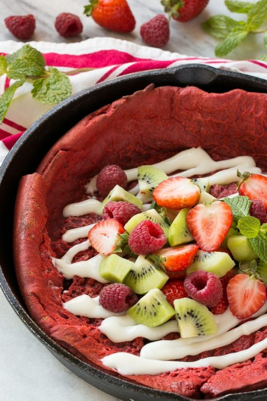 This giant Red Velvet Puffed Pancake bakes up in the oven and is topped with a cream cheese glaze and fresh fruit. It’s a breakfast delight that will brighten up any morning!