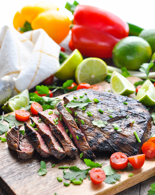 An easy grilled flank steak is transformed into juicy, tender, and flavorful Carne Asada — with just 5 minutes of prep work! Thanks to a simple Latin American-inspired steak marinade, the charred meat is perfect for salads, tacos, burritos and quesadillas.