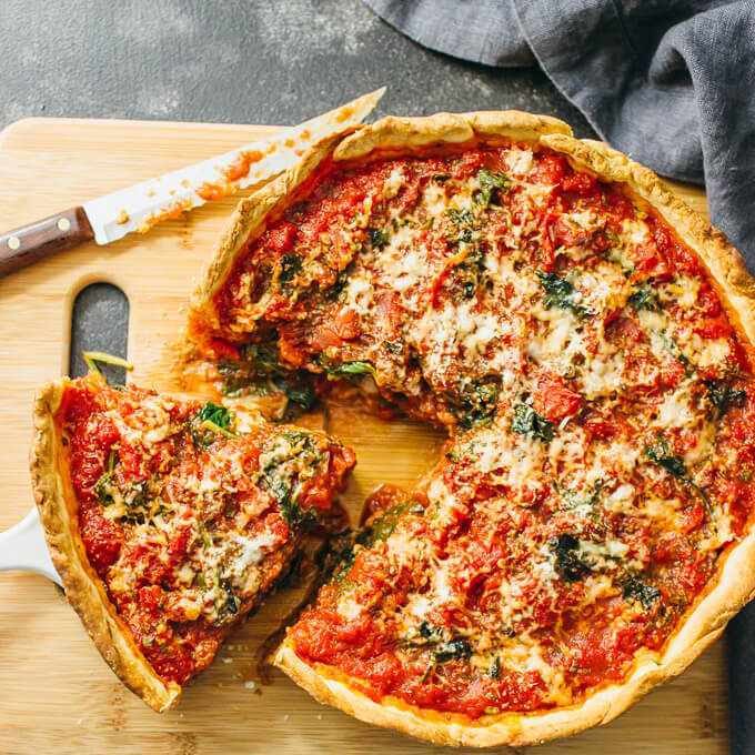 homemade Chicago-style deep dish pizza with spinach from scratch! The dough is easy to prepare and the filling can be made of your favorite pizza toppings.